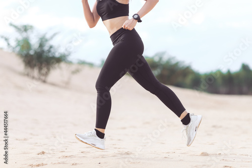 woman running on the beach at sunset