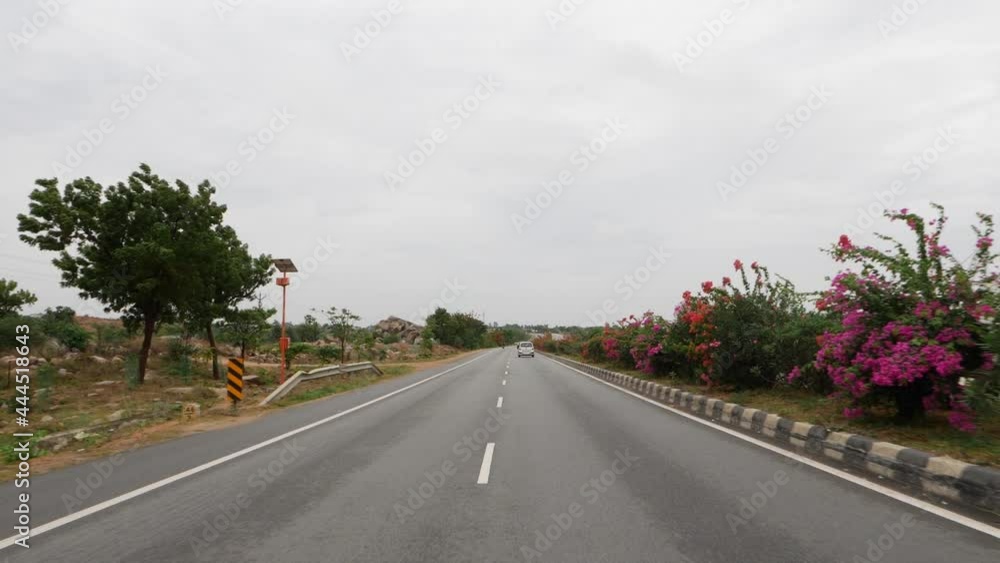 View of flowers on road divider, Four lane road footage View of flowers on road divider, Four lane road footage