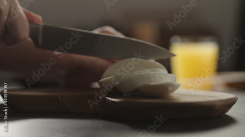 man slicing mozzarella on olive wood board