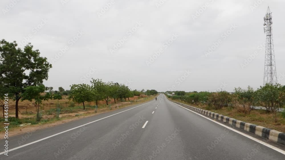 View of four lane road in India, White lines in center of road View of four lane road in India, White lines in center of road