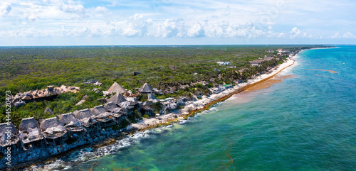 Tulum, Mexico. May 15, 2021. Aerial view of the luxury hotel Azulik in Tulum. Beautiful view of the eco wooden houses in the jungle by the sea shore.