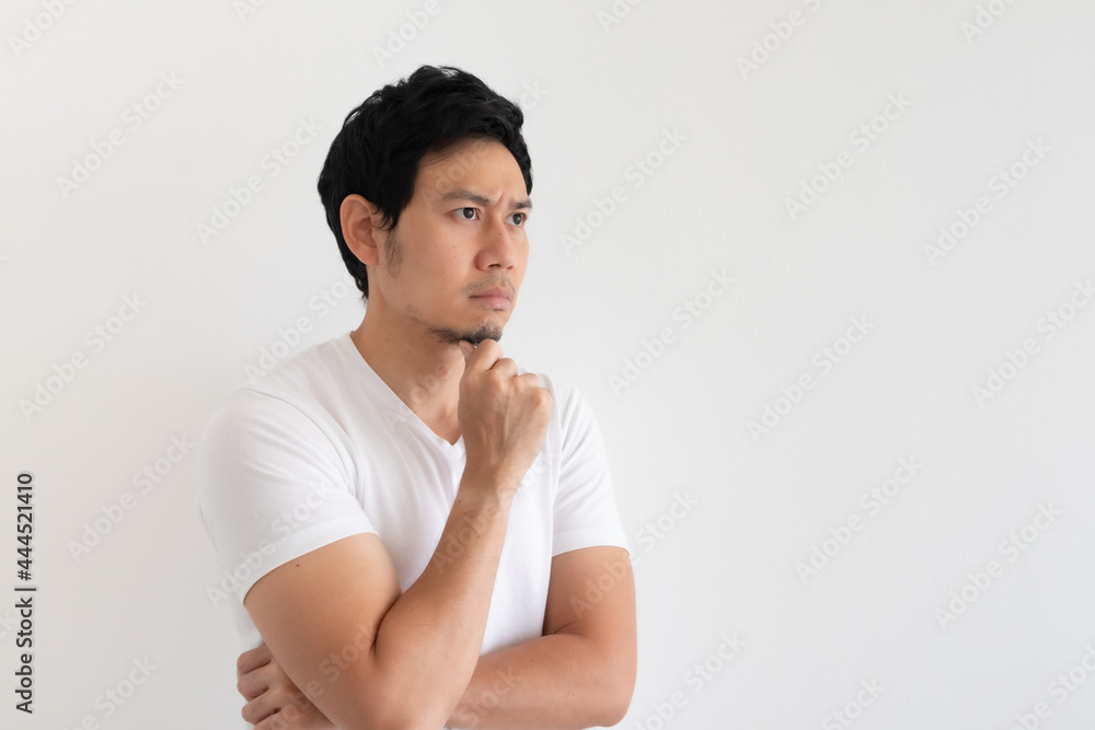 Serious and upset Asian man wears white t-shirt isolated on white background. Serious and upset Asian man wears white t-shirt isolated on white background.