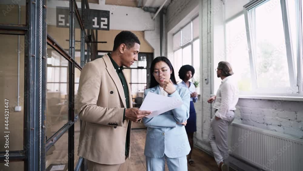 Multiethnic business team at work in their start up industrial office. Multiethnic business team at work in their start up industrial office.