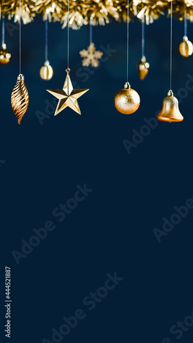 Fotografia merry Christmas decoration golden star bell bauble and tinsel on navy luxury blue vertical background