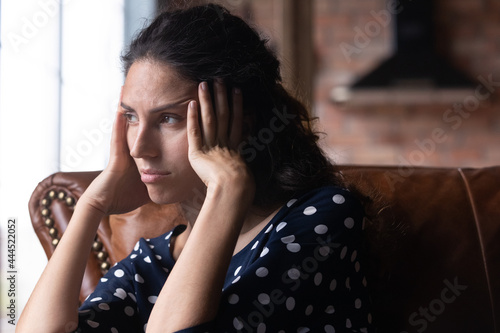 Bored depressed woman feeling apathy, suffering from boredom, negative thoughts, headache, fatigue, holding head, looking away, thinking over problems, bad news, loneliness. Frustration concept