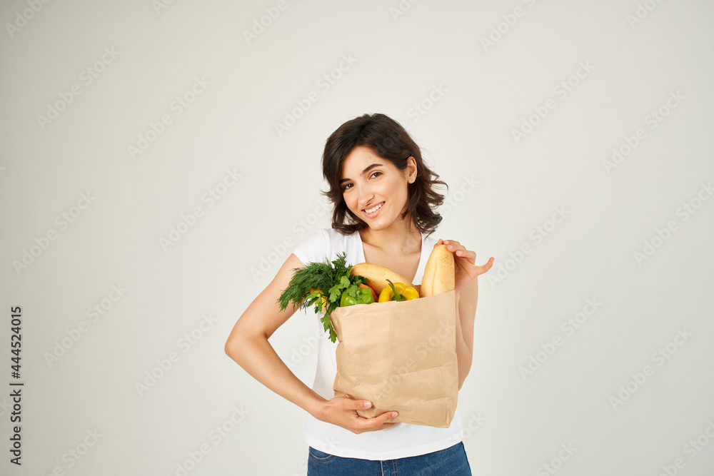 cheerful woman with a package of groceries healthy food supermarket cheerful woman with a package of groceries healthy food supermarket