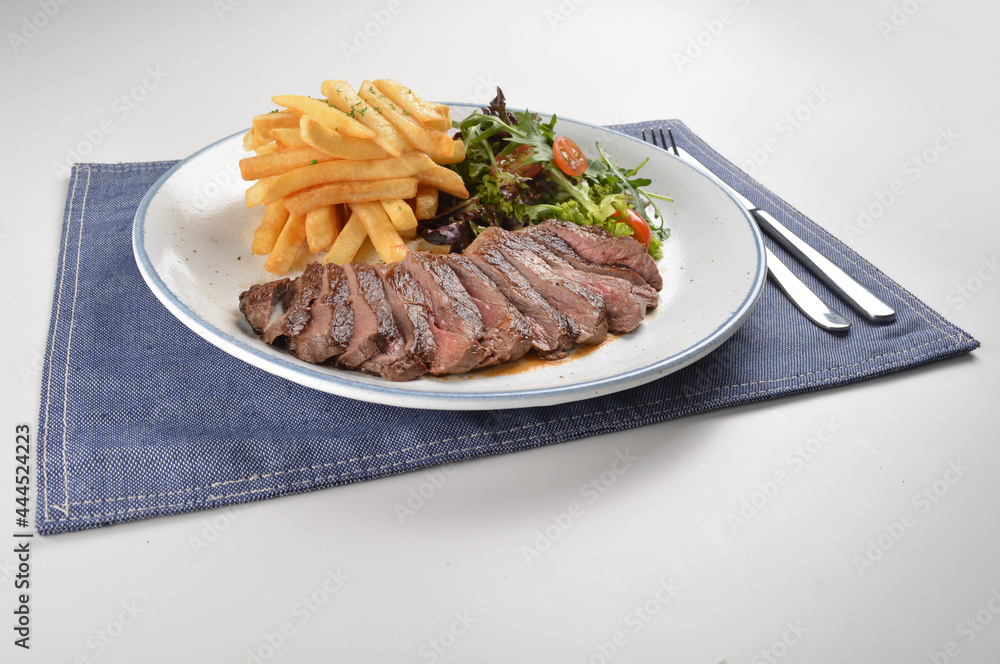 bbq grilled juicy wagyu beef tenderloin sirloin steak in brown black pepper sauce with French fries and vegetables salad dressing western cuisine menu bbq grilled juicy wagyu beef tenderloin sirloin steak in brown black pepper sauce with French fries and vegetables salad dressing western cuisine menu