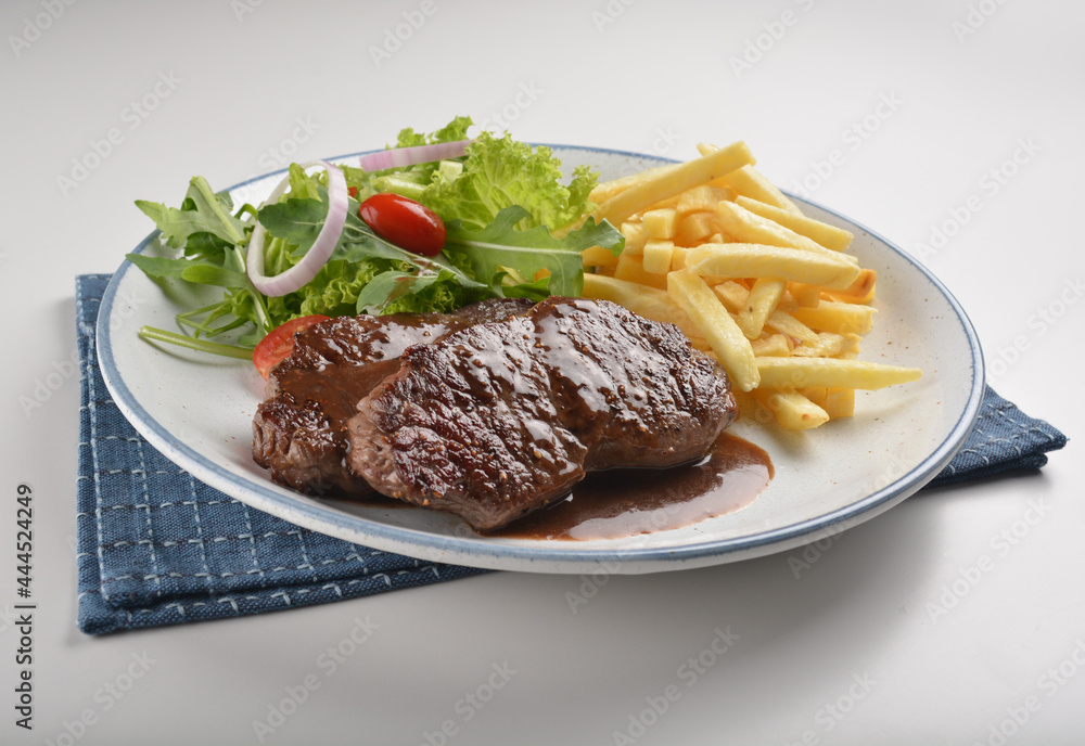 bbq grilled juicy wagyu beef tenderloin sirloin steak in brown black pepper sauce with French fries and vegetables salad dressing western cuisine menu