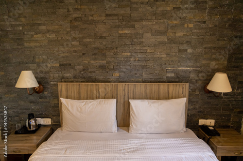 Wallpaper Mural View of a bedroom interior with white linen, bed and bed side lamps and tables neatly arranged Torontodigital.ca