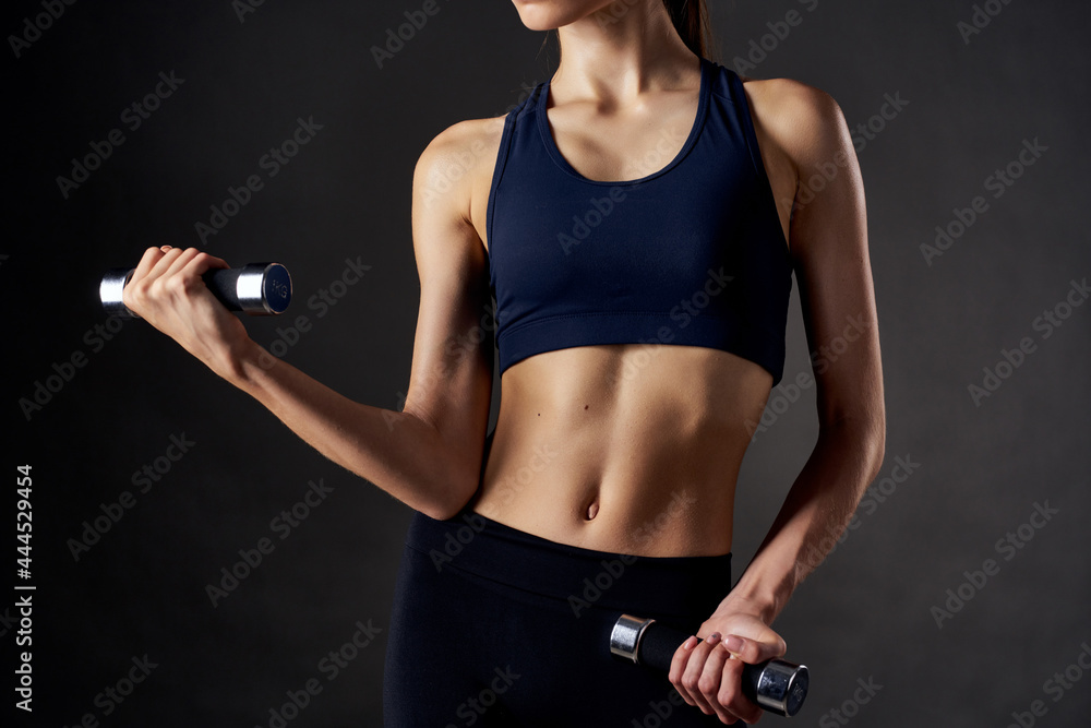 athletic woman with a slim figure with dumbbells in the hands of fitness workout athletic woman with a slim figure with dumbbells in the hands of fitness workout