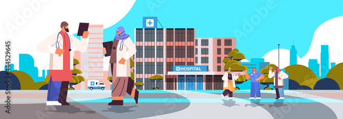 arab doctors in uniform discussing during meeting neat modern hospital building healthcare medicine concept