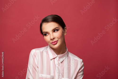 Young adorable woman over red wall smiling