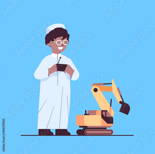 arab schoolboy playing with radio controlled tractor toy smiling boy having fun full length