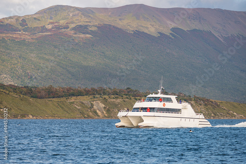 Modern tour boat, catamaran is sailing with tourists at Beagle Channel to watch wildlife in Patagonia, near Ushuaia, Argentina. © neurobite