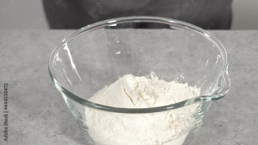 Step by step. Mixing ingredients in a glass mixing bowl to prepare lemon cranberry bundt cake. Step by step. Mixing ingredients in a glass mixing bowl to prepare lemon cranberry bundt cake.