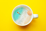 Woman swim in coffee mug with sea vacation concept