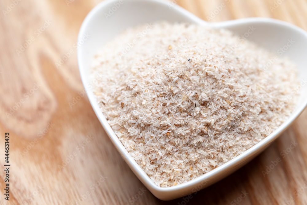 Portion of Psyllium Seeds on rustic wooden background. Natural light. Selective focus. Portion of Psyllium Seeds on rustic wooden background. Natural light. Selective focus.