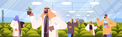 arab agricultural engineers researching plants in greenhouse agriculture scientist smart farming concept