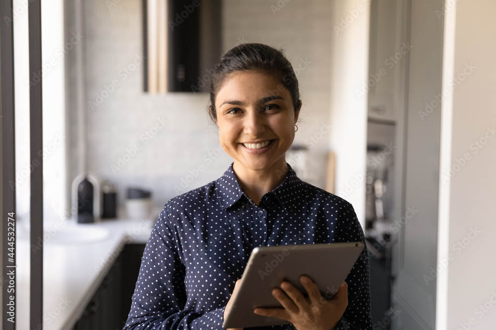 Portrait of happy Indian female customer using app service on tablet for online learning, shopping and ordering, electronic payment, remote business work, looking at camera, smiling, Head shot Portrait of happy Indian female customer using app service on tablet for online learning, shopping and ordering, electronic payment, remote business work, looking at camera, smiling, Head shot
