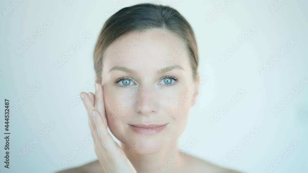 Portrait of a beautiful young woman taking care of her facial skin Portrait of a beautiful young woman taking care of her facial skin
