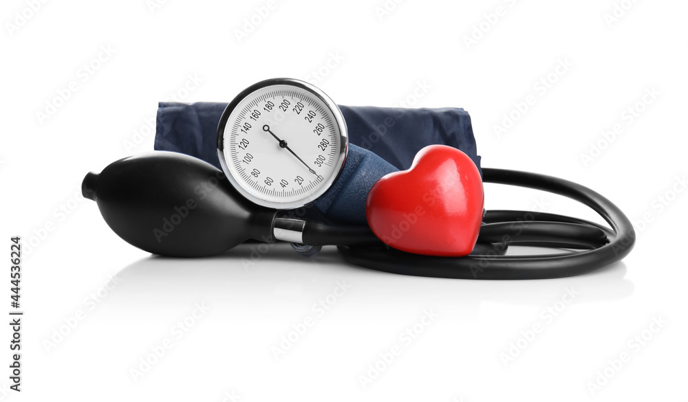 Blood pressure meter and toy heart on white background Blood pressure meter and toy heart on white background