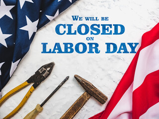 LABOR DAY. Hand tools and the Flag of the United States of America lying on the table. View from above, close-up. Congratulations to family, relatives, friends and colleagues. National holiday concept