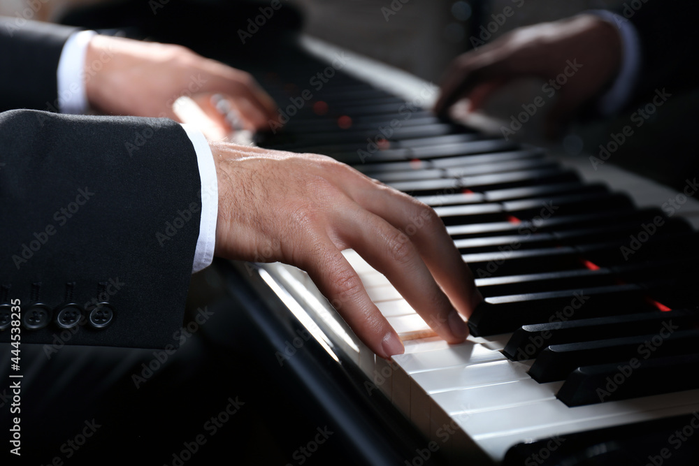 Obraz premium Man playing grand piano, closeup. Talented musician