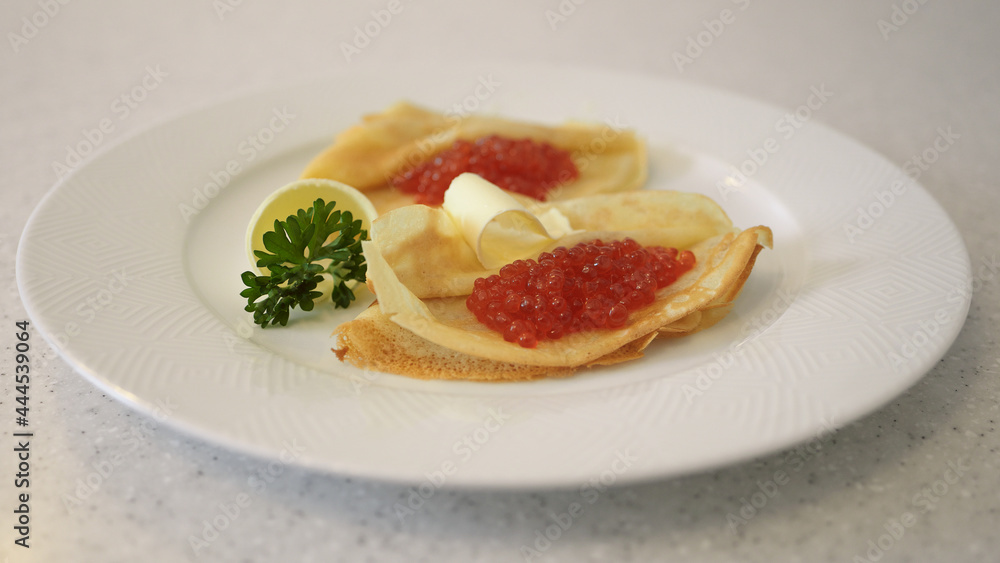 Russian pancakes with caviar and butter
