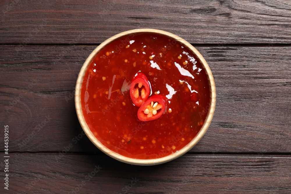 Spicy chili sauce in bowl on wooden table, top view Spicy chili sauce in bowl on wooden table, top view