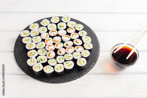 Set of sushi rolls on black plate