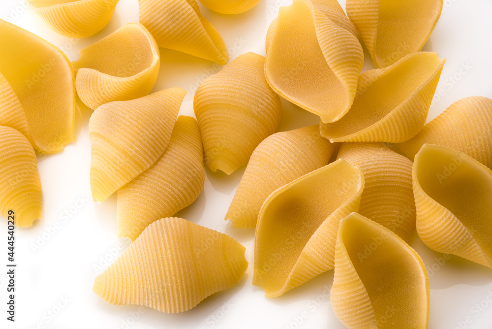 Italian raw dry pasta conchiglioni bronze drawn isolated on white background. Produced in Gragnano, Naples, Italy Italian raw dry pasta conchiglioni bronze drawn isolated on white background. Produced in Gragnano, Naples, Italy