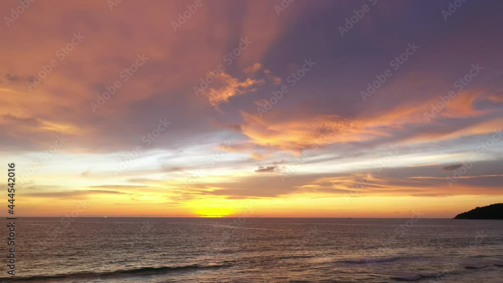 drone shooting stunning sunset at the sea in twilight.. video 4K. Nature video High quality footage. .Scene of colorful red light trough in the sky background. drone shooting stunning sunset at the sea in twilight.. video 4K. Nature video High quality footage. .Scene of colorful red light trough in the sky background.