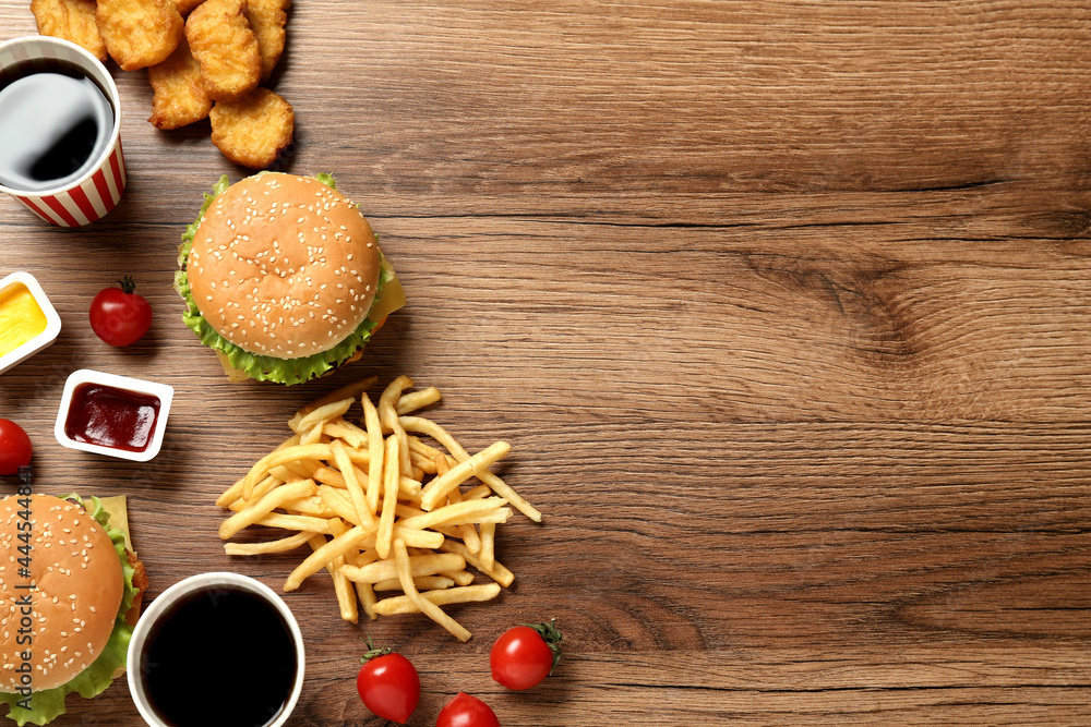 Flat lay composition with delicious fast food menu on wooden table. Space for text Flat lay composition with delicious fast food menu on wooden table. Space for text