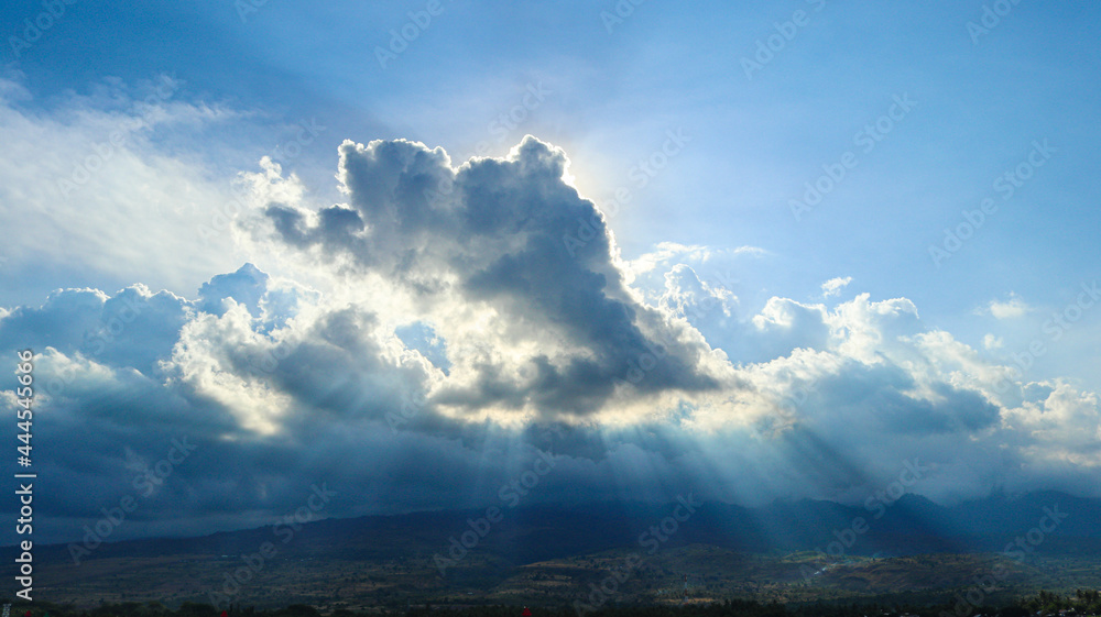 Morning cloudy sky under the Rinjani Mountain in Lombok and the sun shines through the clouds Morning cloudy sky under the Rinjani Mountain in Lombok and the sun shines through the clouds