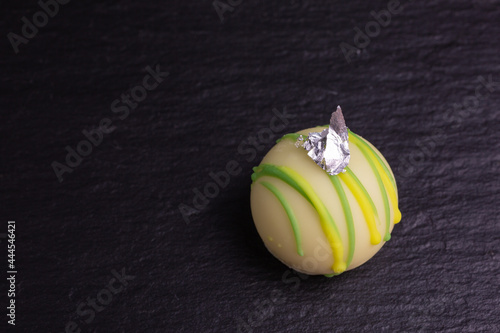 piece of edible silver leaf on chocolate truffle photo