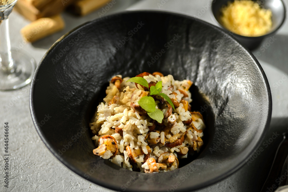 chanterelle risotto in a black plate chanterelle risotto in a black plate
