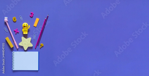 Back to school concept. School and office supplies on the office table. Violet background.Flat lay