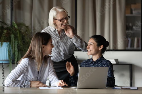 Fotografija Diverse female office team discussing project and laughing