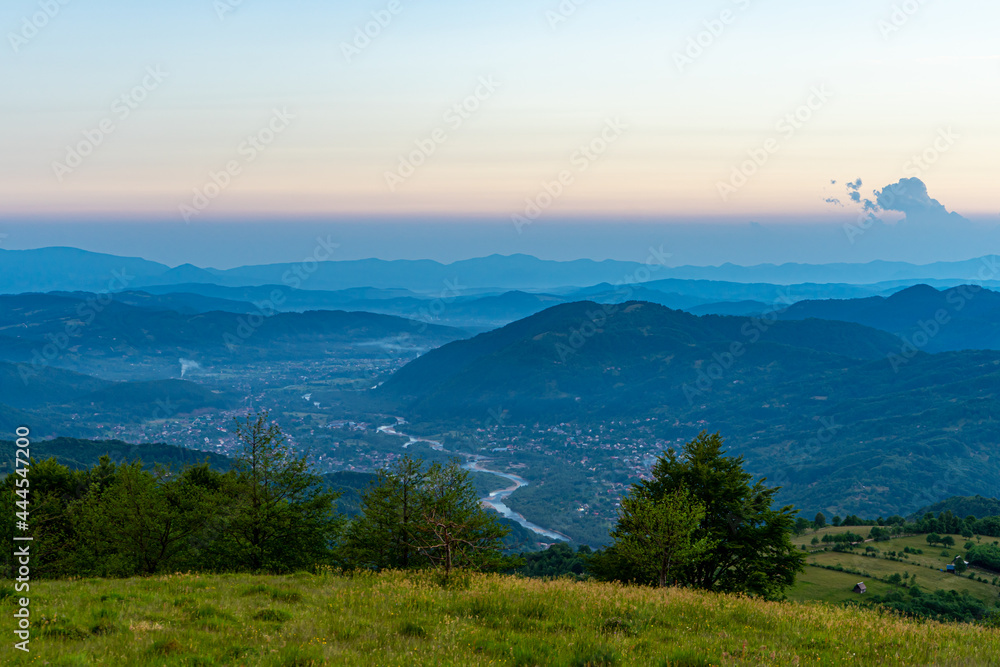 Sunset panoramic view of River Teresva and Dubove village from Apetska mountain, Carpathians mountains, Ukraine.