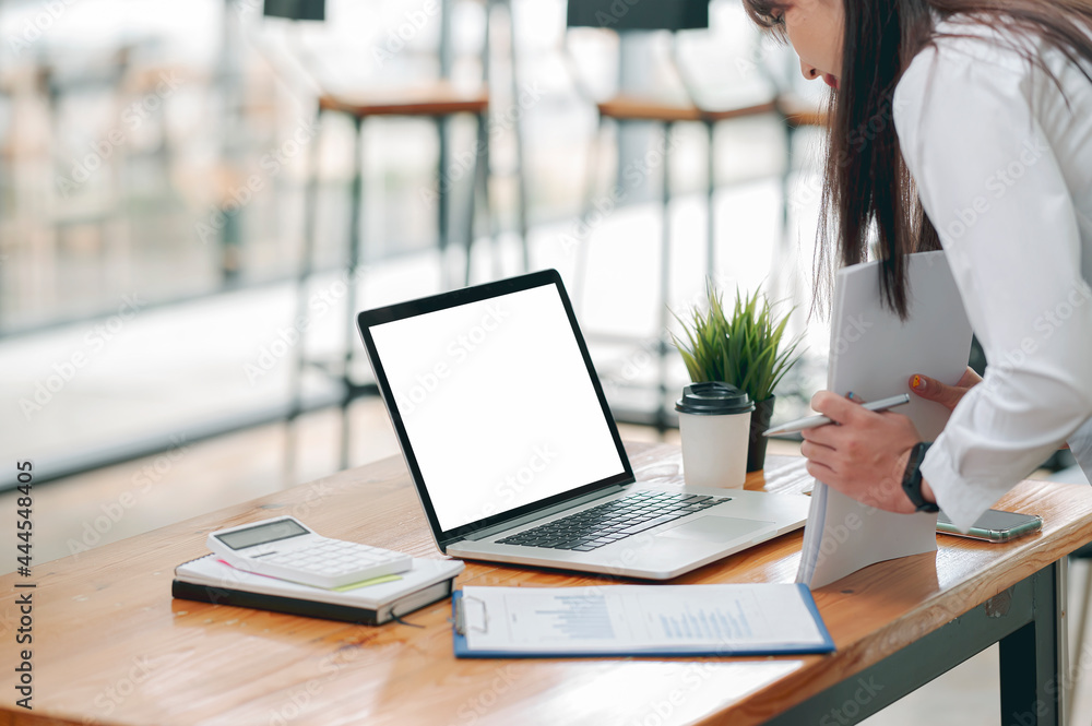 Woman preparing for finish work after working on laptop at office. Woman preparing for finish work after working on laptop at office.