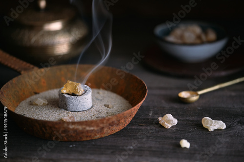 Burning frankincense resin (olibanum) on glowing charcoal