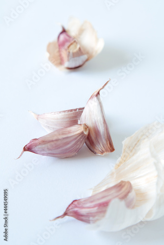4 parts of a pink garlic on a white background