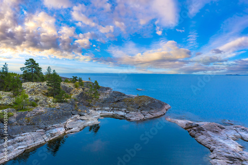 Karelia on a summer day. Russian landscape. The nature of Russia. Beautiful sky over Lake Ladoga. Ladoga skerries. Travel to Karelia. Outdoor recreation. Sky, water, and rocks. Bright sky with clouds.