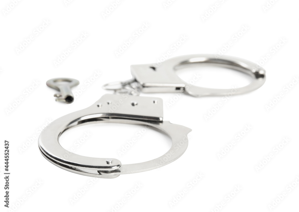 Classic chain handcuffs with key on white background Classic chain handcuffs with key on white background