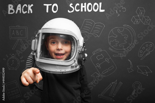 The child plans to go back to school wearing an astronaut helmet to become an astronaut © vovan