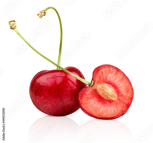 one whole and one sliced cherries on white isolated background