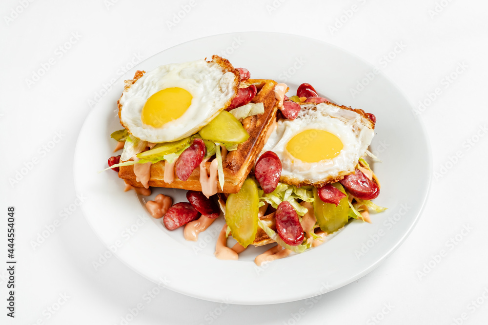 belgian waffle with fried egg and sausage