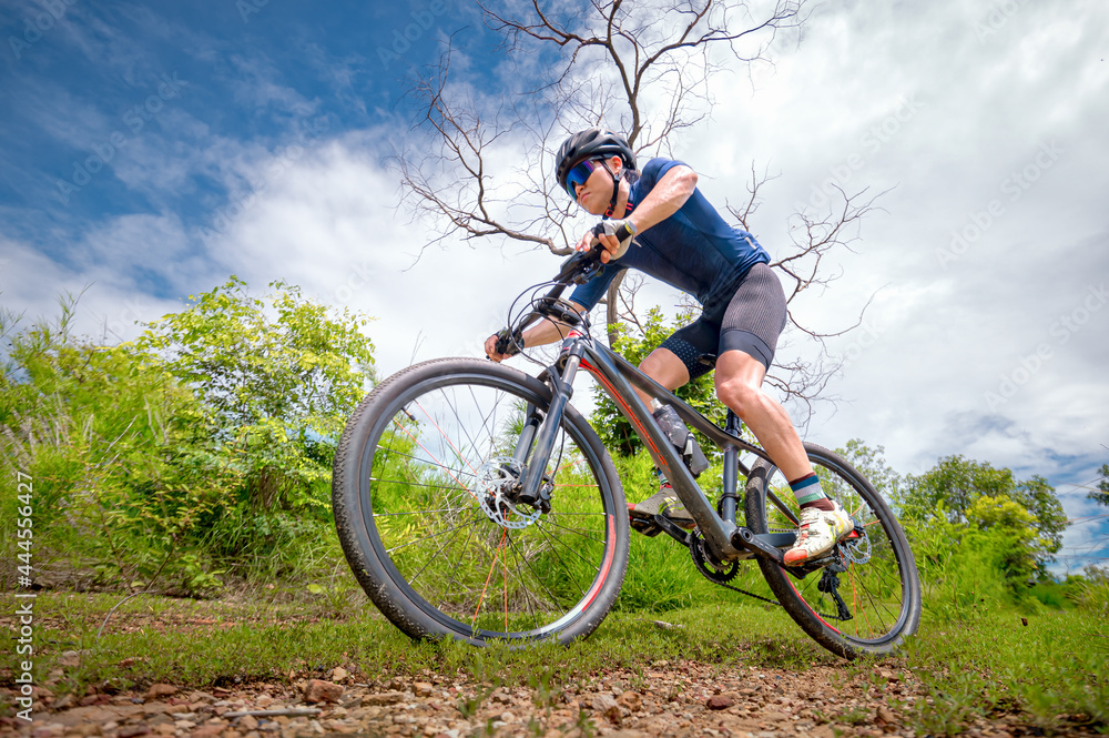 Mountain bikers ride MTB, mountain bike downhill to the extreme. Asian man  rides MTB, mountain bike downhill in the wild to extremes. Extreme Sport  and MTB, mountain bike downhill Concept. Stock Photo