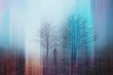 A double exposure of a spooky half transparent hooded figure. Over layered over an abstract, artistic, retro edit. On a moody foggy winters day in the countryside. Malvern Hills, UK
