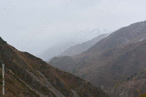 Mountains in the fog. Fall. Overcast. Ile-Alatau mountains, Almaty region, Kazakhstan.